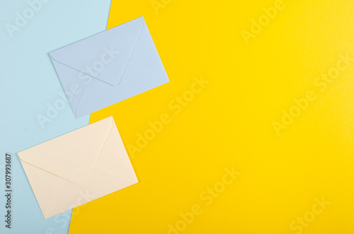 Paper envelope composition on blue background. Flat lay.