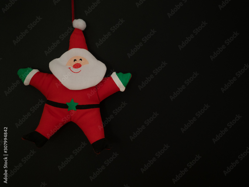 Fabric Santa Ornament Against a Black Background Fabric Santa Ornament Against a Black Background