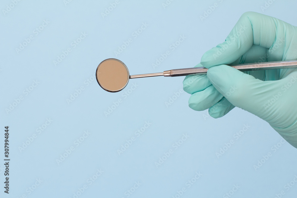 Dentist's hand in glove with mouth mirror. Dentist's hand in glove with mouth mirror.