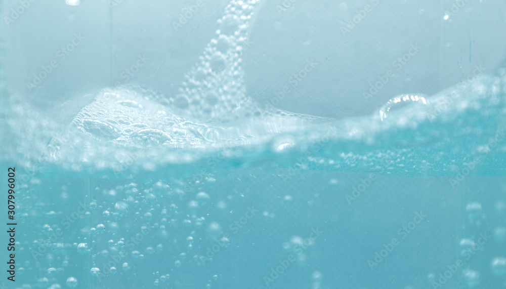 Water and soap bubbles on the water surface, water waves, blue water  