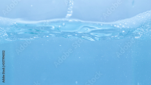 Water and soap bubbles on the water surface, water waves, blue water 