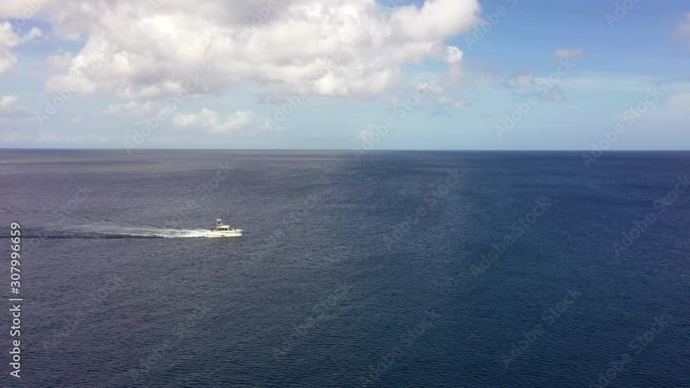 Aerial view over coast of Curaçao / Caribbean Sea with boat in turquoise water Aerial view over coast of Curaçao / Caribbean Sea with boat in turquoise water