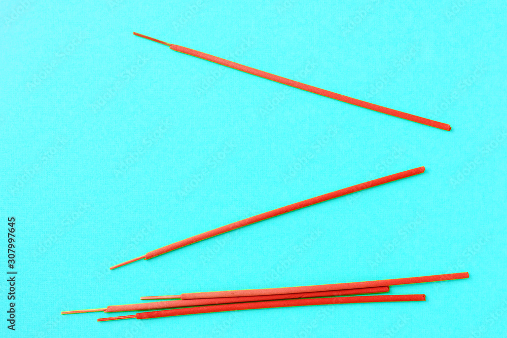 Aroma sticks red color on a blue background. Flat lay, copy space Aroma sticks red color on a blue background. Flat lay, copy space