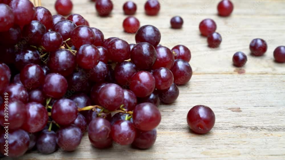 Red grape on a wooden table ,Right-to-left pan shot Red grape on a wooden table ,Right-to-left pan shot