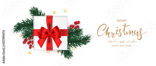 Merry Christmas and Happy new year banner. Gift box decorated with red bow  green pine branches holly berry and star on white background.  Vector illustration.