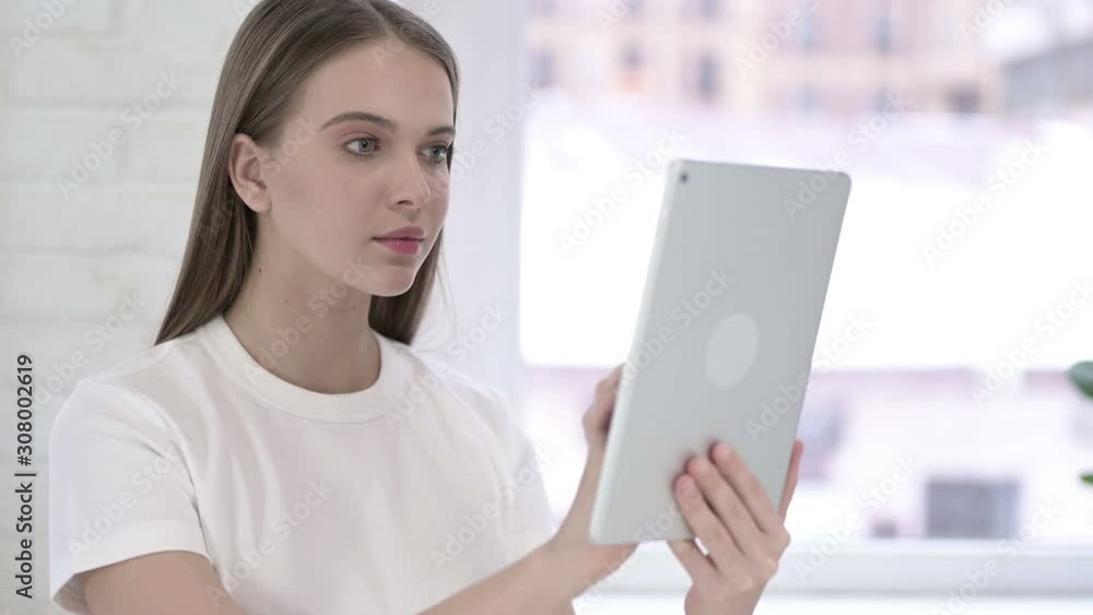 Portrait of Serious Young Woman using Tablet Portrait of Serious Young Woman using Tablet