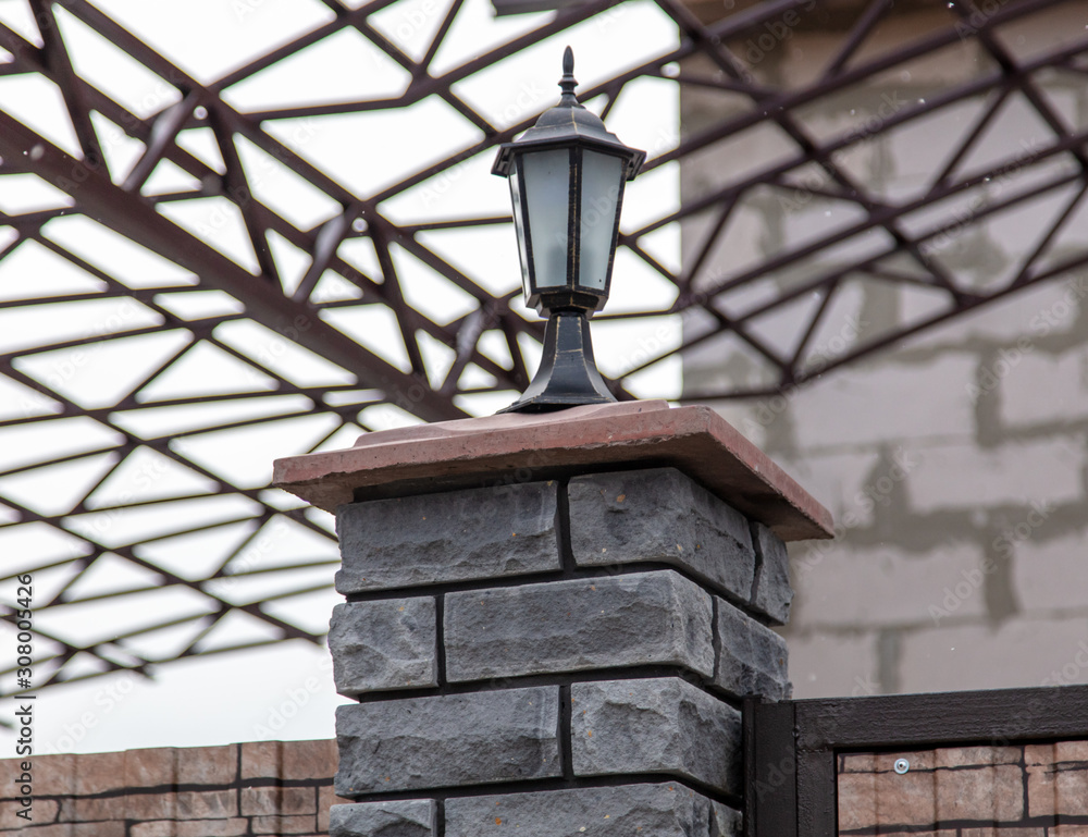 Lantern on the fence in a house under construction