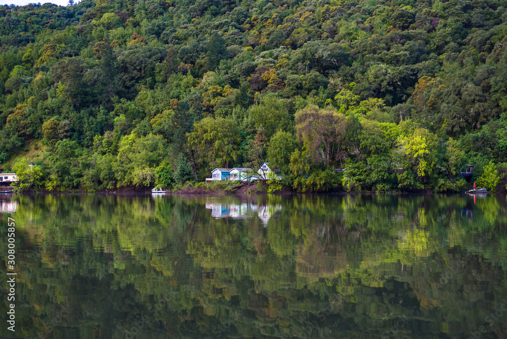 Lakeside building nested in the green foliage on the hillside Lakeside building nested in the green foliage on the hillside