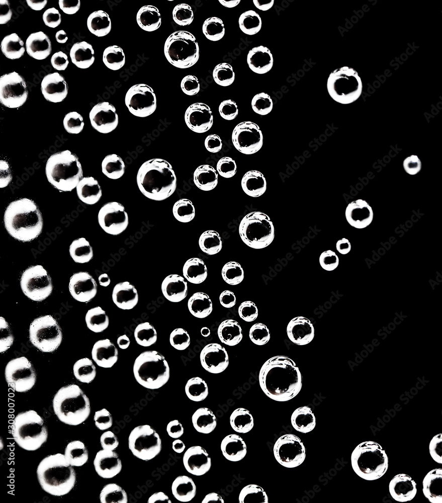 Air balls in water on a black background