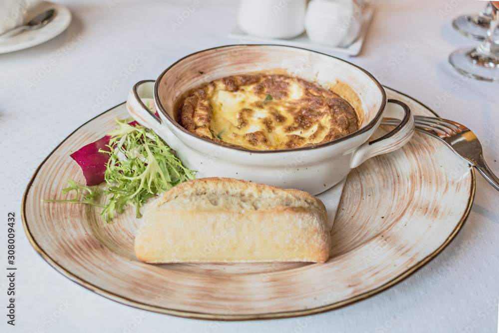 Baked omelet for breakfast with cutlery on the table. Livestyle. Baked omelet for breakfast with cutlery on the table. Livestyle.