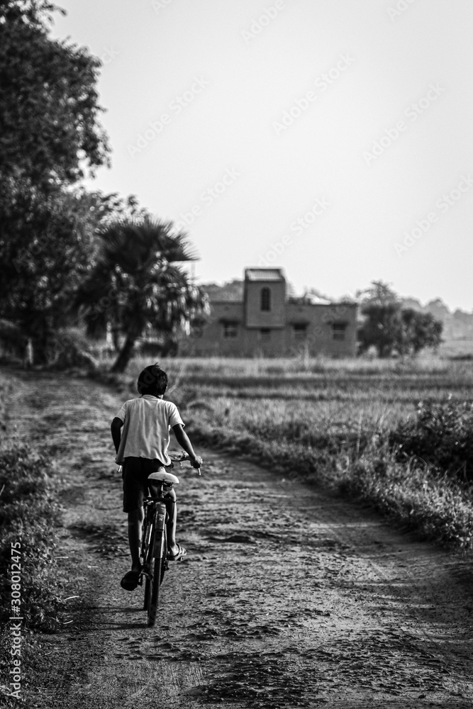 boy cycling in indian vilag