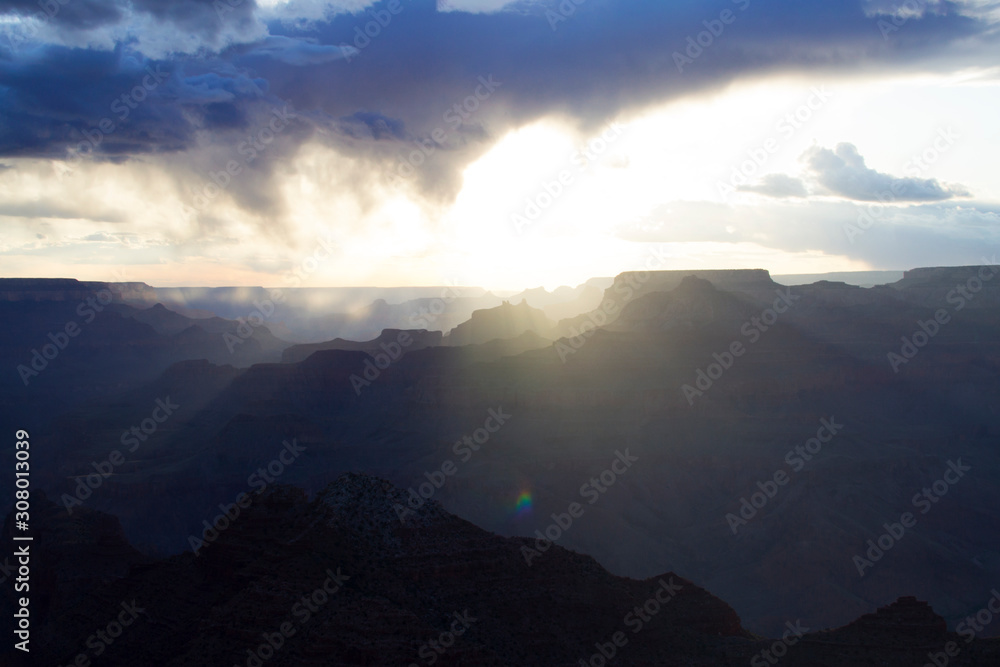 Grand Canyon National Park. Incredibly beautiful sunny sunset. The sky with a huge cloud, a mountain range. Colorful landscape. Mountains , layout for design. Clouds in trendy classic blue color 2020.
