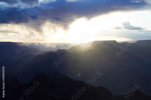 Grand Canyon National Park. Incredibly beautiful sunny sunset. The sky with a huge cloud, a mountain range. Colorful landscape. Mountains , layout for design. Clouds in trendy classic blue color 2020.