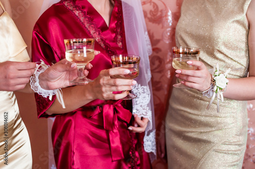 bride and groom clink glasses with champagne