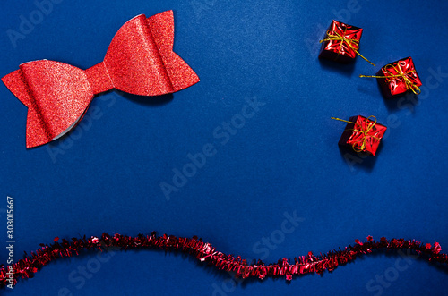 Top view of red christmas decorations in a conceptual image of the coming new year. Over blue background.