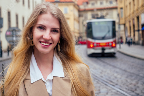 blonde woman stand in bus stop and waiting trolley in Prague sity Chezh