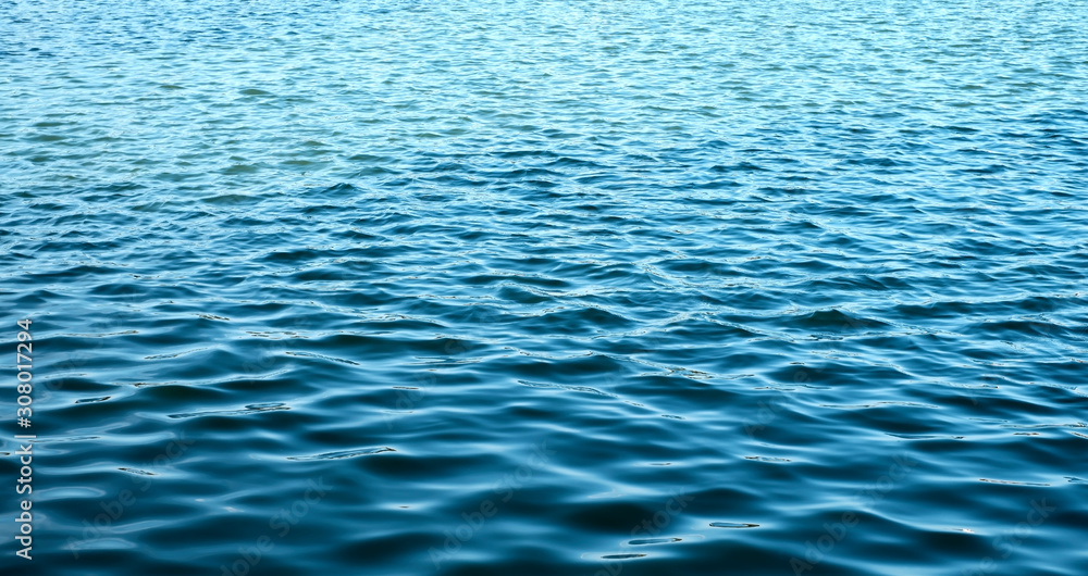 ripples on the marine blue water background ripples on the marine blue water background