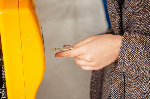 Young woman hand inserts the bus ticket into the validator, validating and ticking in Prague sity Chezh photo
