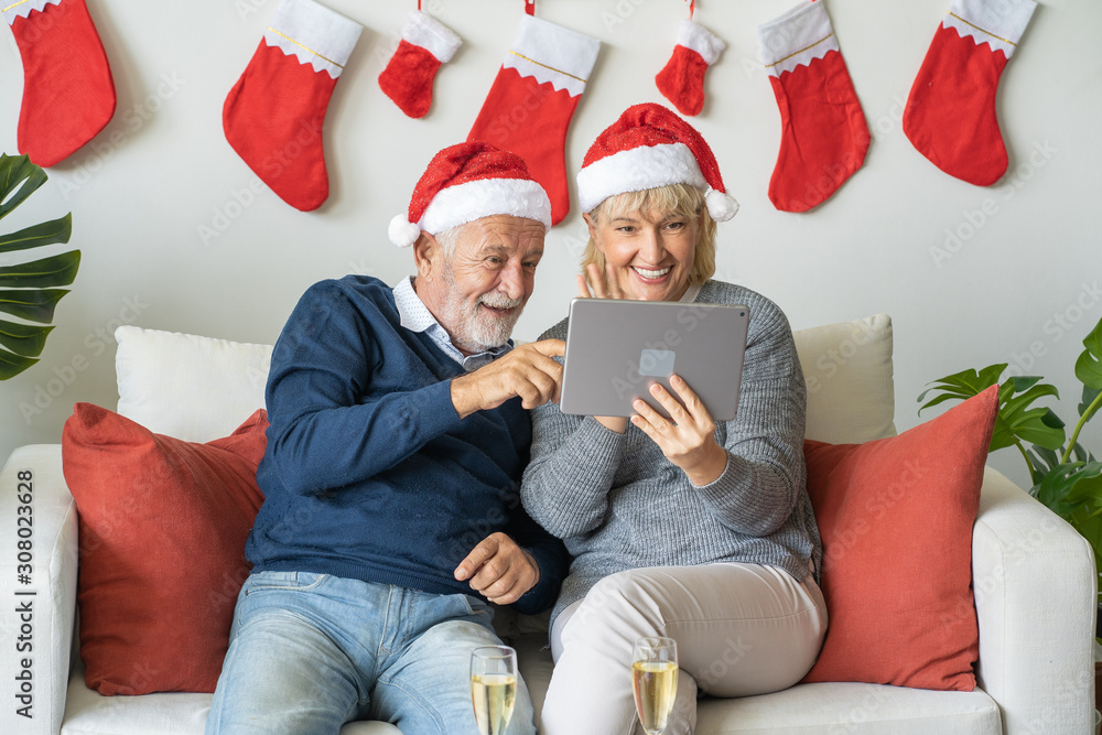 Senior couple using conference on tablet with family together at home for Christmas festival day, Retirement lifestyle concept Senior couple using conference on tablet with family together at home for Christmas festival day, Retirement lifestyle concept