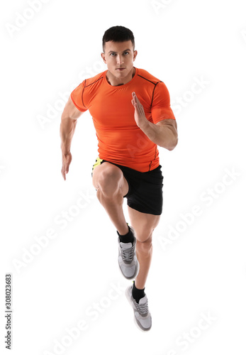 Athletic young man running on white background