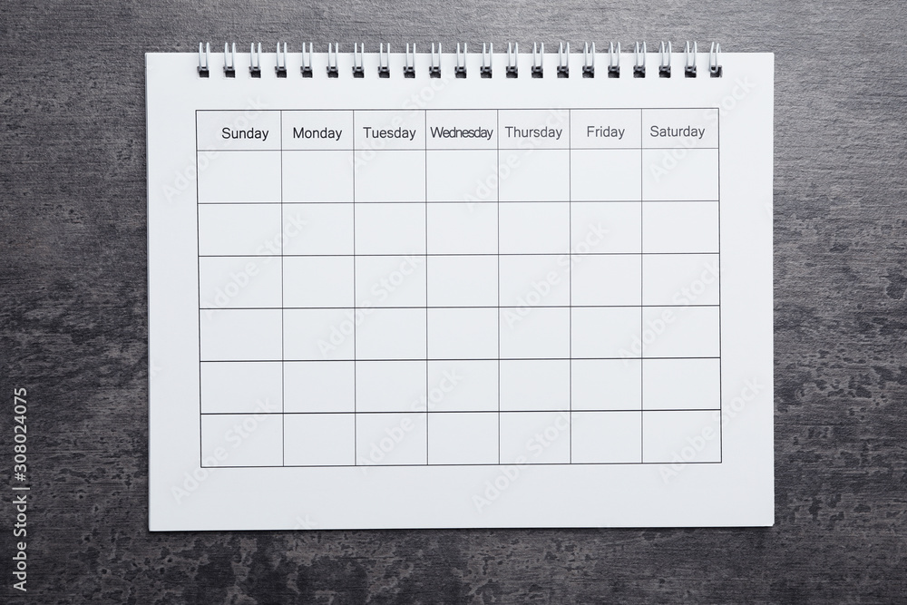 Blank calendar on grey stone background, top view Blank calendar on grey stone background, top view