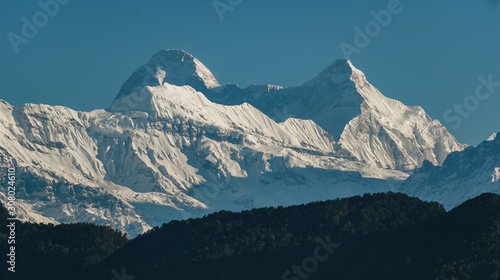 A view of a landscape of scenic Himalayas peaks from a hillside in the village of Chaukori in the state of Uttarakhand in India.