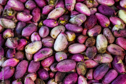 Background of fresh pistachio nuts on the Eastern Bazaar. Fresh pistachios close up. Some of the nuts are open.
