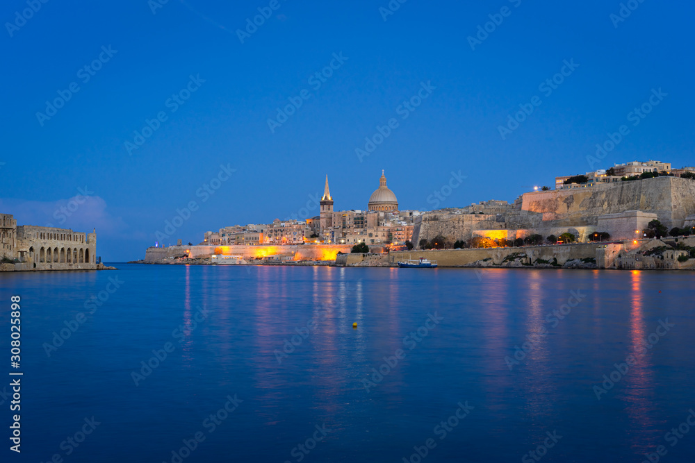 Malta. Valletta skyline at sunset with Basilica and Lazzaretto of Manoel Island, viewed from Ta Xbiex