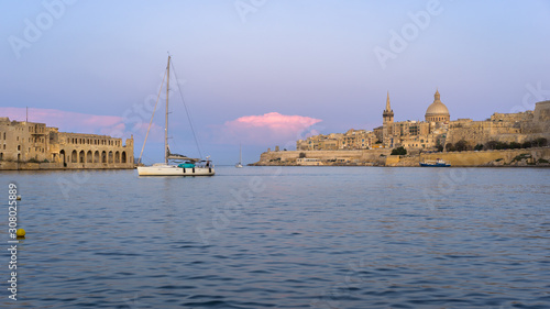 Malta. Valletta skyline at sunset with Basilica and Lazzaretto of Manoel Island, viewed from Ta Xbiex