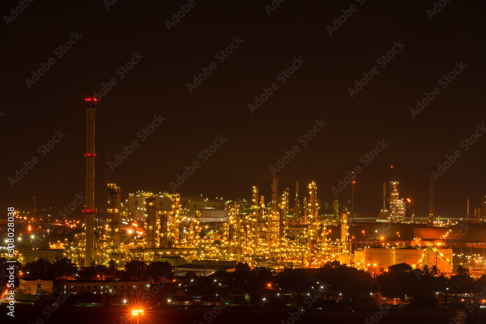 The colorful lights in oil refinery industry power station at night time with Twilight sky ,Chonburi,Thailand.