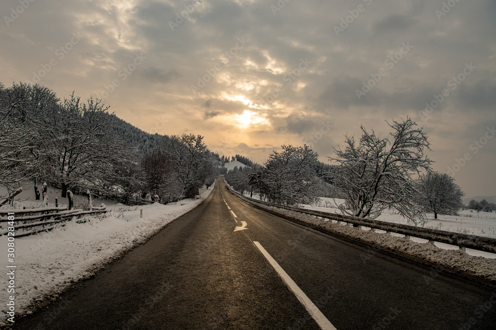 road in winter with sun glow
