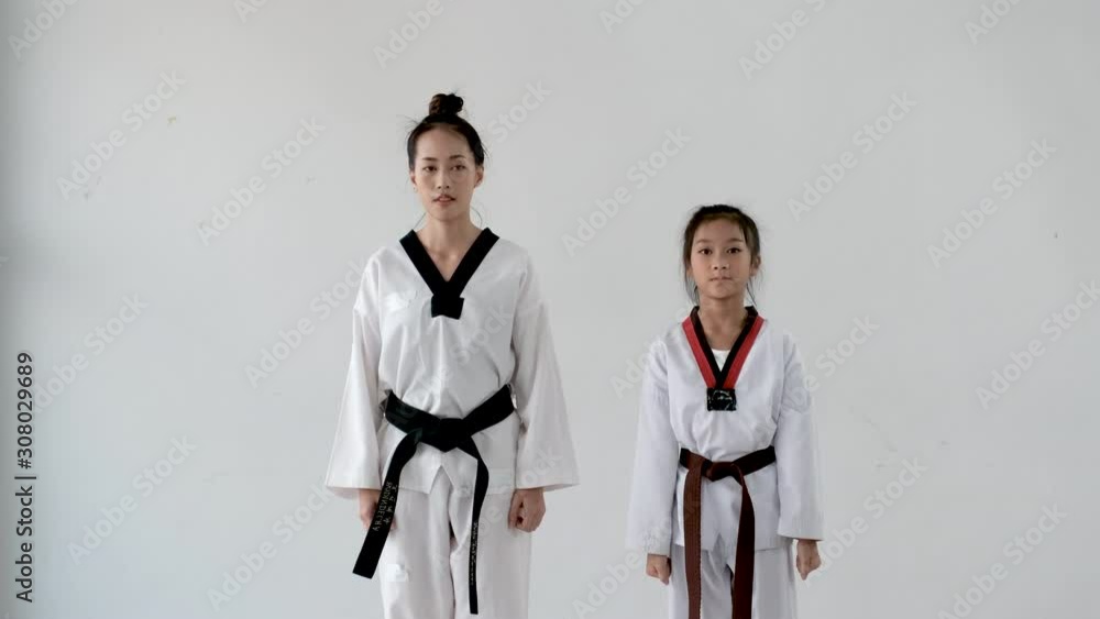 Taekwondo teacher and student woman and girl stand for prepare of