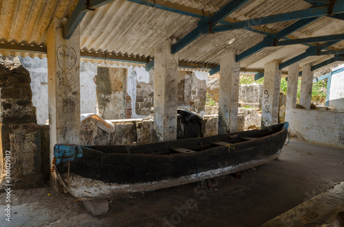 Abandoned old wooden boat inside a Ruins of fish market.