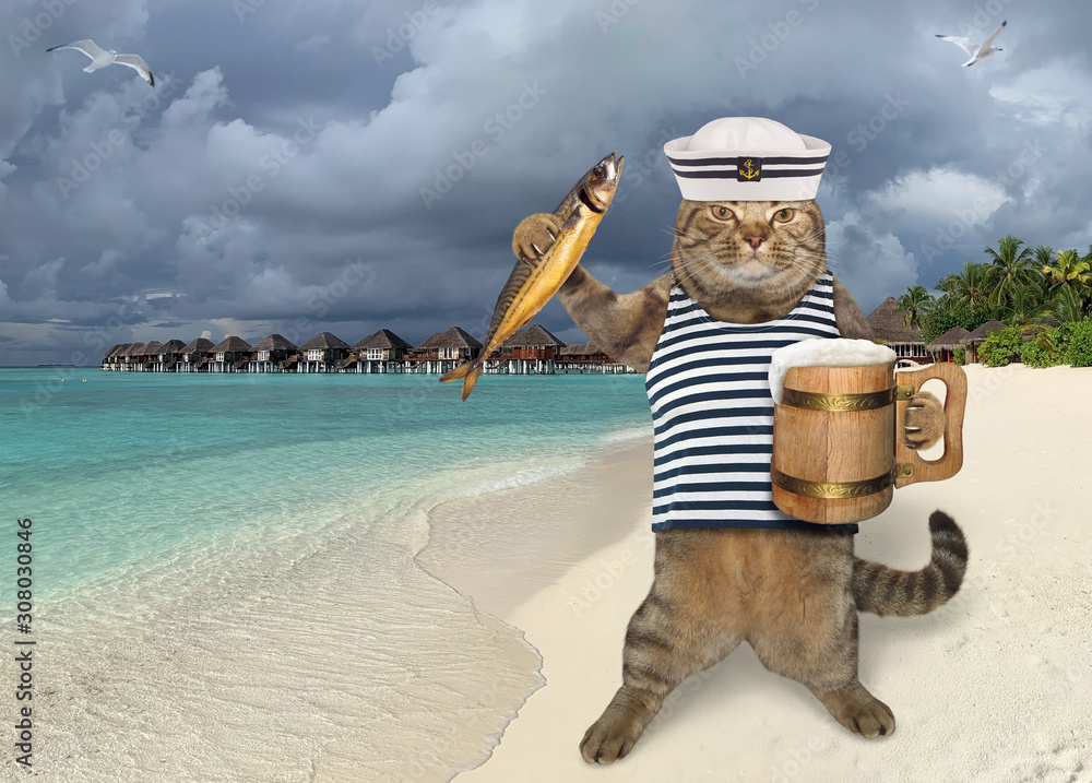 Φωτογραφία The beige cat dressed in sailor clothes is holding a wooden mug of beer and a smoked fish on the tropical beach of Maldives