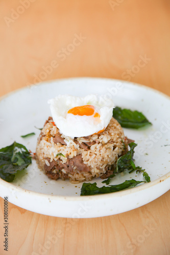 Fried rice with beef, holy basil and thai herb served with poached egg