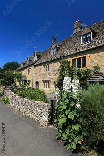 Summer view over Honey-Coloured Cottages, Lower Slaughter village, Gloucestershire Cotswolds, England, UK