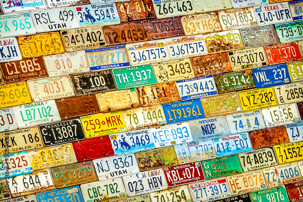 St Elmo, CO, USA - Old Colorful American USA License Plate Car Registration Tags from Different States Decorating a House Wall in Colorado