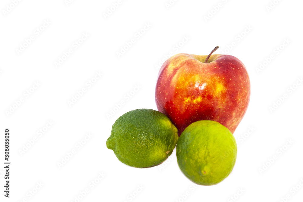Two limes and a red apple on a white background Two limes and a red apple on a white background