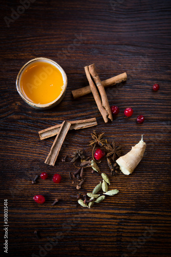 Fototapeta Naklejka Na Ścianę i Meble -  honey cinnamon and ginger on a wooden table