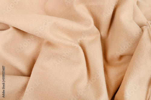 A soft beige blanket background.