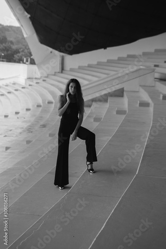 Beautiful girl posing in the stadium. Shows old fashion in Tallinn.