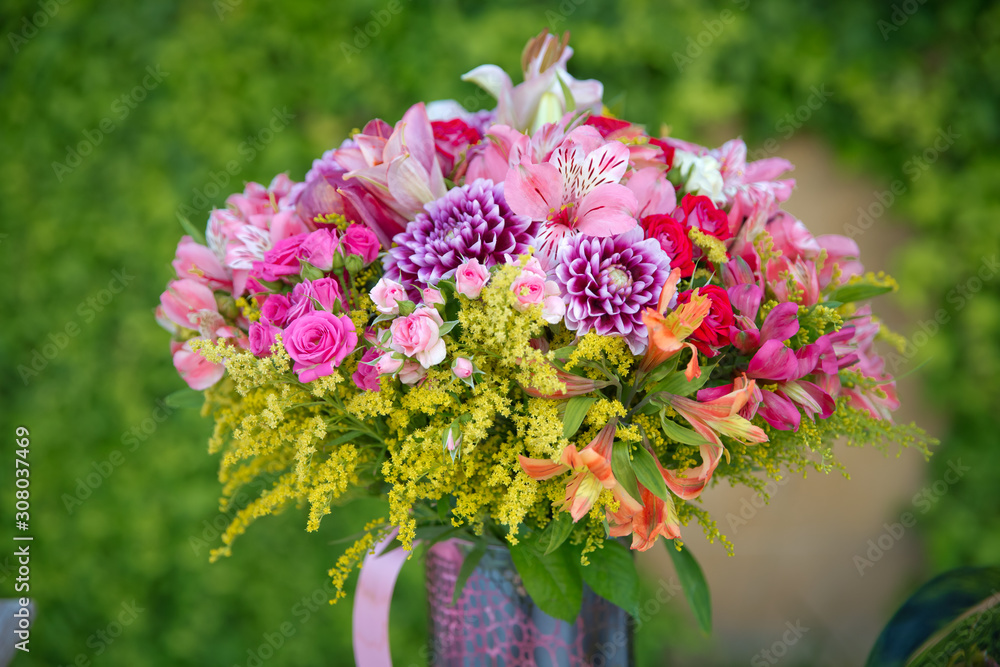 Beautiful wedding colorful purple bouquet for bride. Beauty of colored flowers. Flowers backgrounds . Beautiful bunch of colorfull flowers with pink, purple , white, red and yellow flowers .