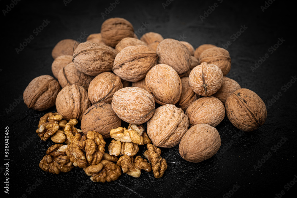 Walnut on over black slate stone background Walnut on over black slate stone background