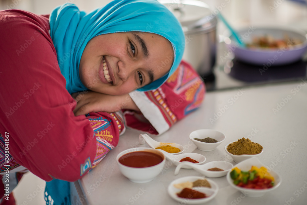 Muslim traditional woman working in kitchen Muslim traditional woman working in kitchen