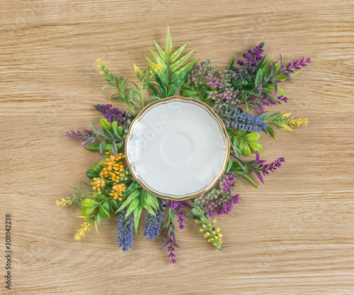 Wildflowers and empty white porcelain plate