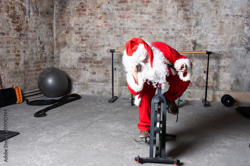 Fitness. Funny Santa Claus and gym.