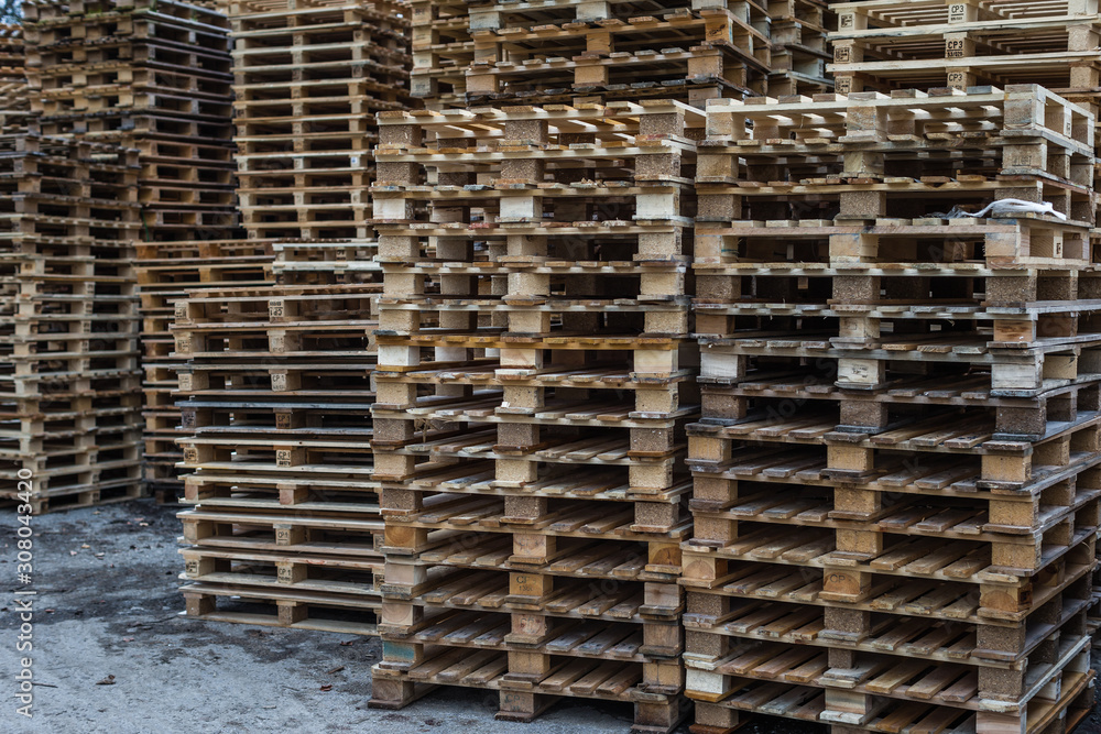 Big stack of wooden pallets at warehouse