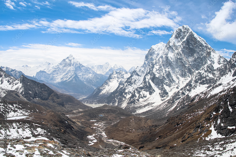 Ama Dablam, Cholatse and Taboche mountain peaks rises above valley near Cho La pass in Sagarmatha national park in Himalayas. Route to Everest base camp through Gokyo lakes. 