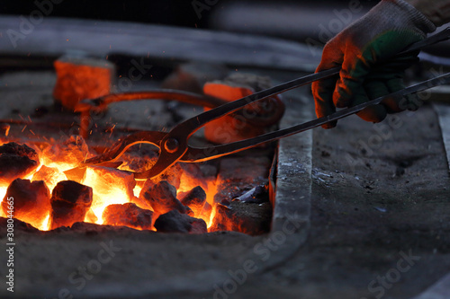 Canvas Print Hot coals in a furnace for heating metal for manual forging in a blacksmith work