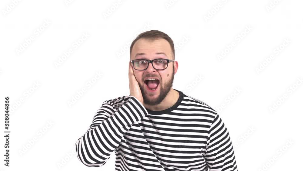 Young Caucasian man imitating phone talk and expressing excitement. Human emotions. Young Caucasian man imitating phone talk and expressing excitement. Human emotions.